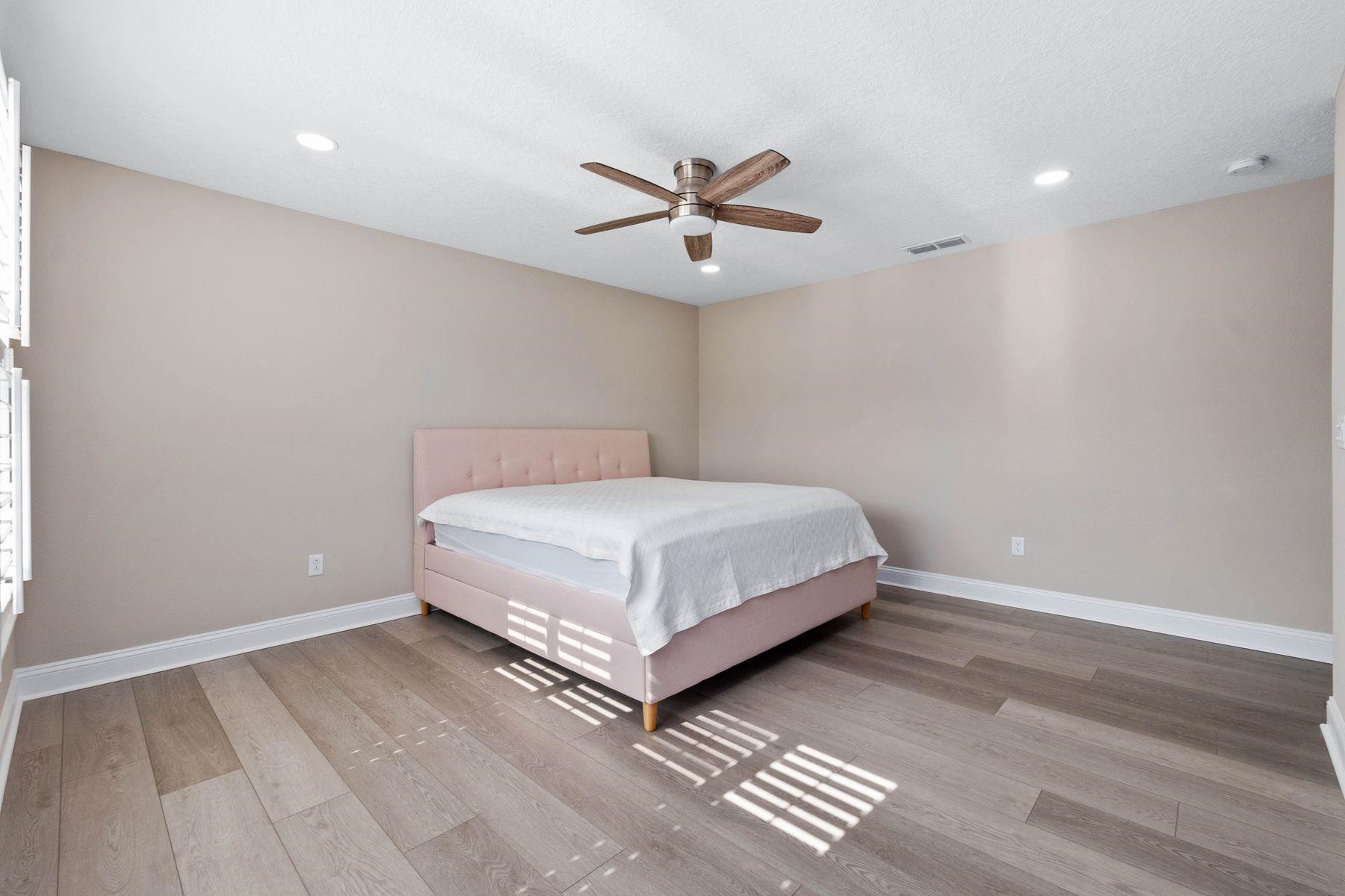 91 Ridgewind Drive St. Augustine, FL 32092 - Photo 21 of 49 a bedroom with a bed and a ceiling fan