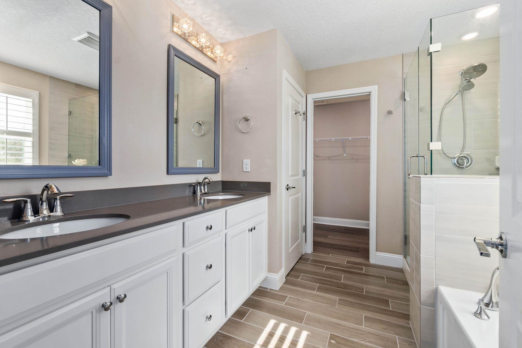 91 Ridgewind Drive St. Augustine, FL 32092 - Photo 23 of 49 a spacious bathroom with double vanity and mirrors
