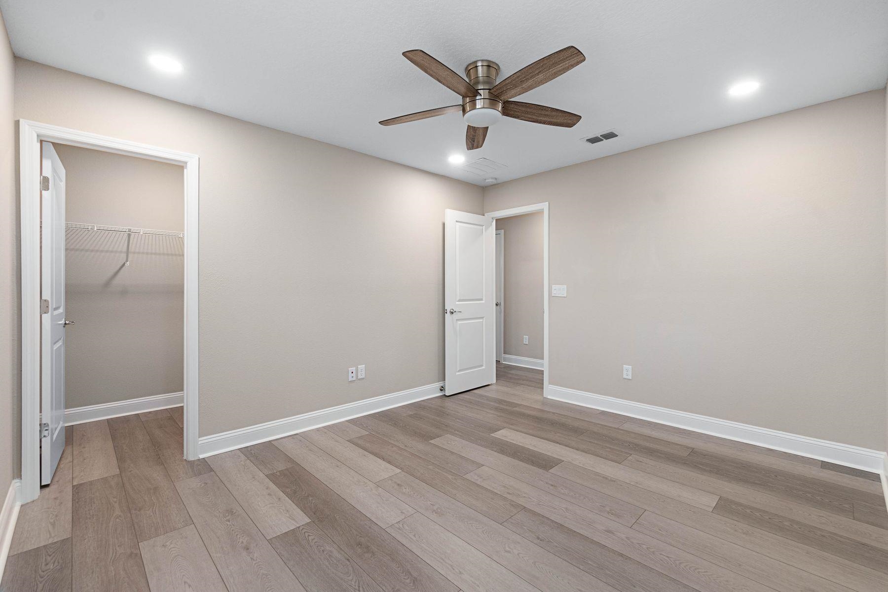 91 Ridgewind Drive St. Augustine, FL 32092 - Photo 27 of 49 an empty room with wooden floor and a ceiling fan