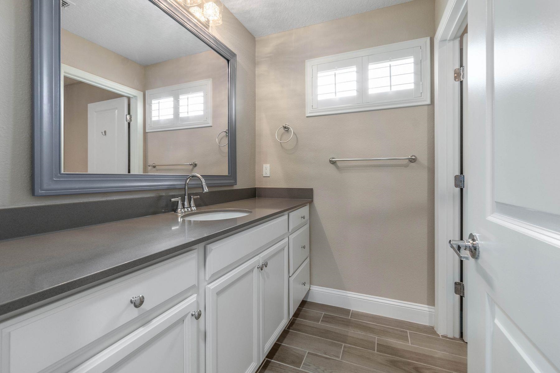 91 Ridgewind Drive St. Augustine, FL 32092 - Photo 29 of 49 a bathroom with a double vanity sink and a mirror