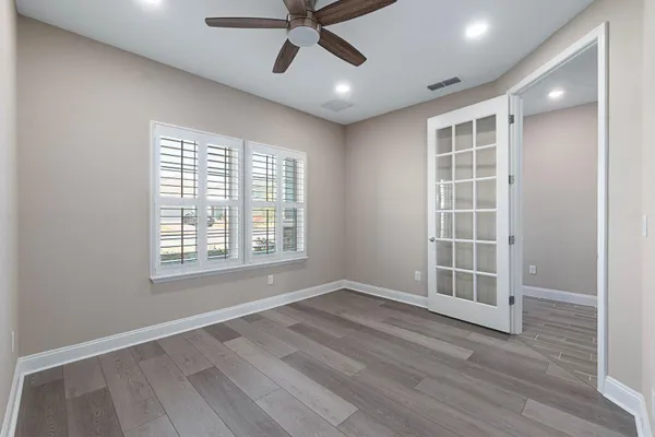 a living room with furniture window and a view of kitchen