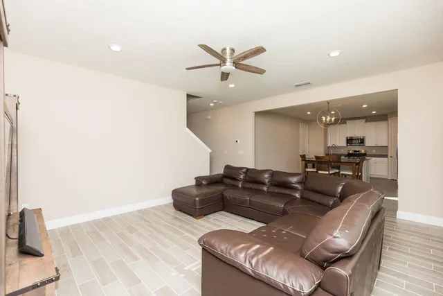 a view of a dining room with furniture wooden floor and chandelier