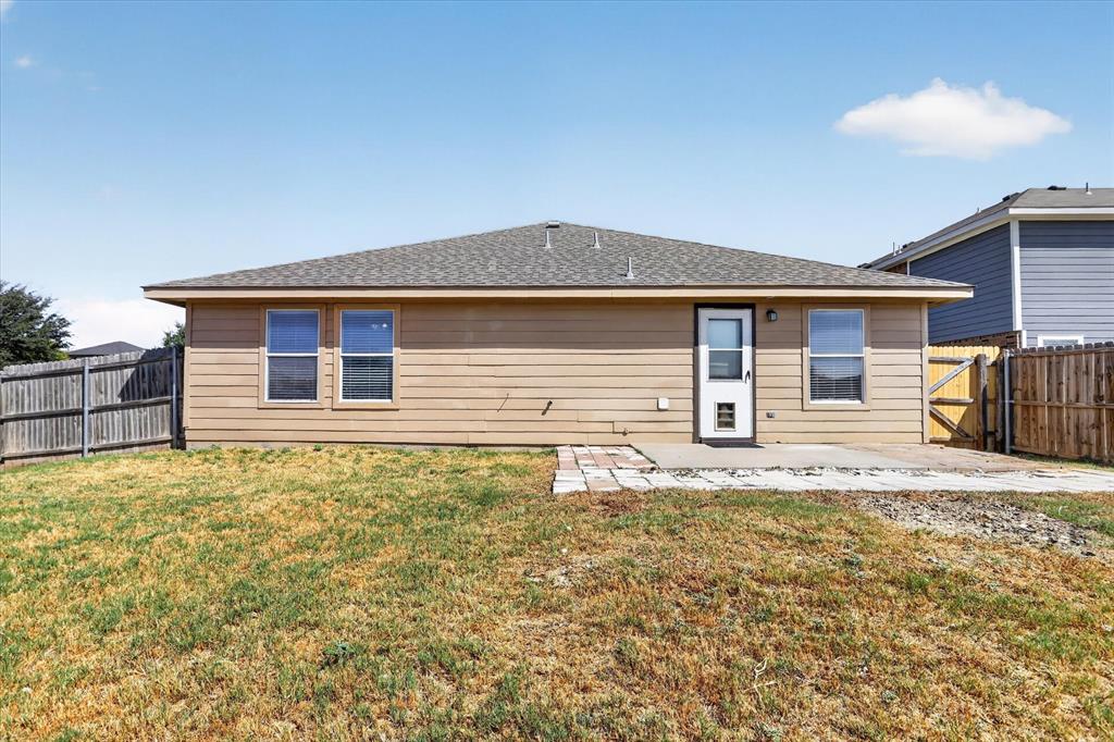 12933 Azure Heights Place Rhome, TX 76078 - Photo 34 of 37 Rear exterior featuring horizontal siding, a composite shingle roof, a concrete patio, and a wood privacy fence