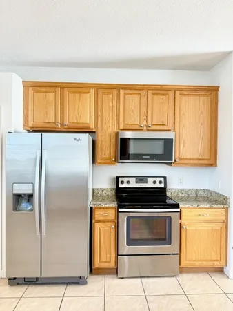 a kitchen with stainless steel appliances granite countertop a stove a sink and a granite counter tops