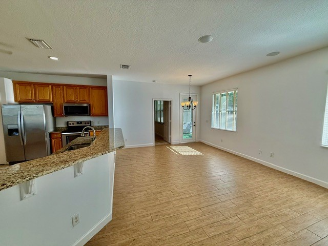 5475 East 1st Square Southwest Vero Beach, FL 32968 - Photo 6 of 19 a view of a kitchen with a sink and refrigerator