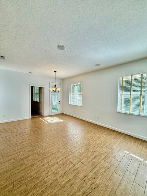 5475 East 1st Square Southwest Vero Beach, FL 32968 - Photo 7 of 19 an empty room with large windows