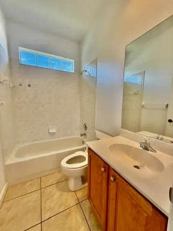 a kitchen with granite countertop a refrigerator stove and microwave
