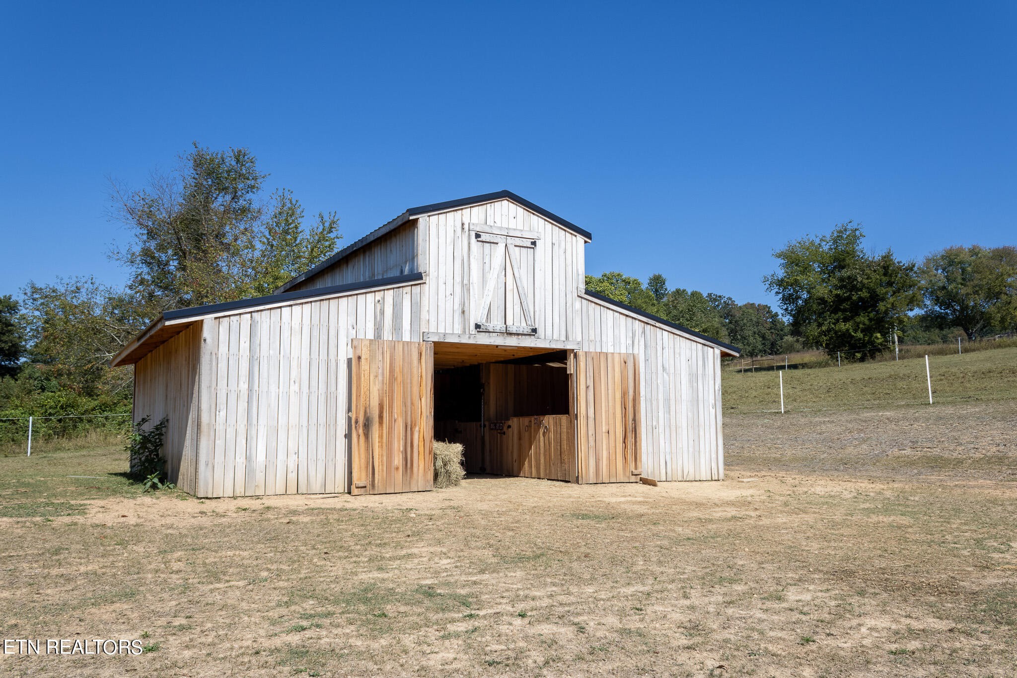 0 New Corinth Road Blaine, TN 37709 - Photo 8 of 17 a front view of a house with a yard and garage