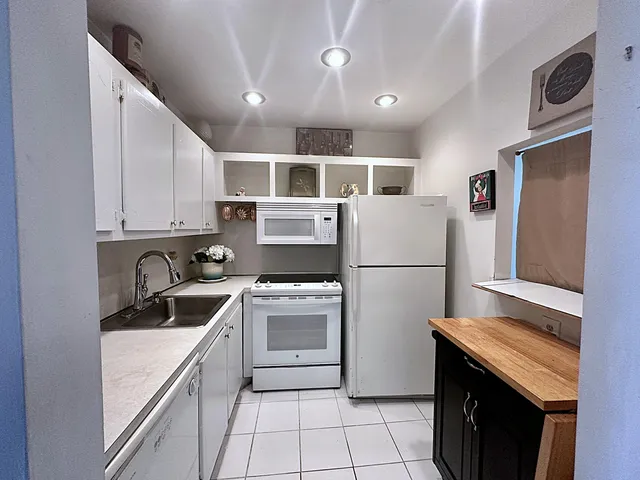 a kitchen with a stove sink and refrigerator