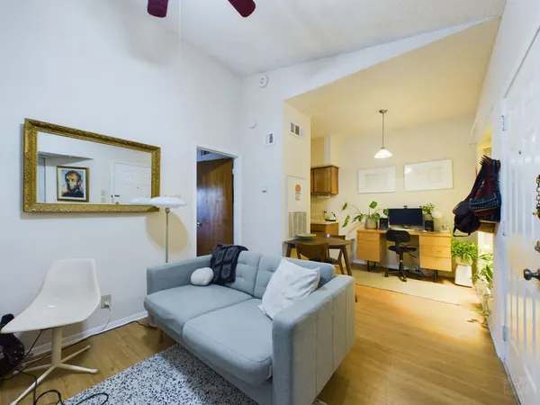 a living room with furniture and a wooden floor