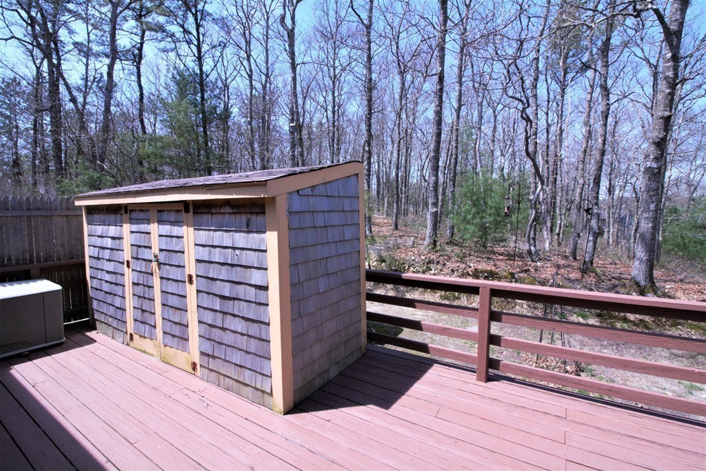 27 Round House Road, Unit 27 Bourne, MA 02532 - Photo 13 of 13 a view of a wooden deck and a backyard