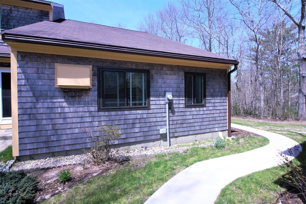 27 Round House Road, Unit 27 Bourne, MA 02532 - Photo 2 of 13 a front view of a house with a garden