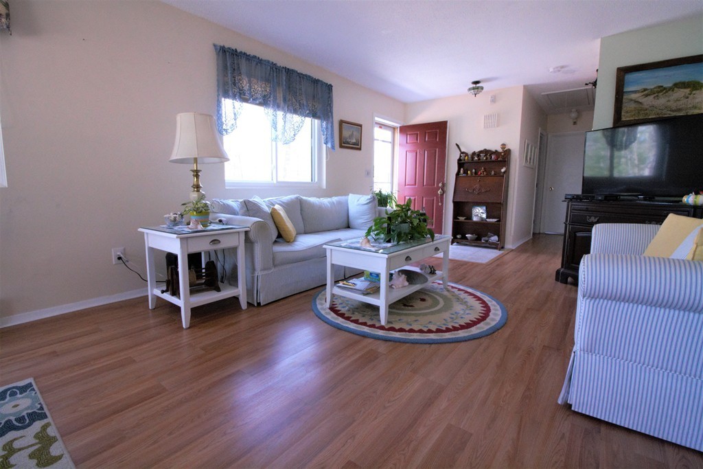 27 Round House Road, Unit 27 Bourne, MA 02532 - Photo 4 of 13 a living room with furniture flat screen tv and a large window