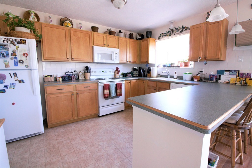 27 Round House Road, Unit 27 Bourne, MA 02532 - Photo 6 of 13 a kitchen with sink cabinets and window