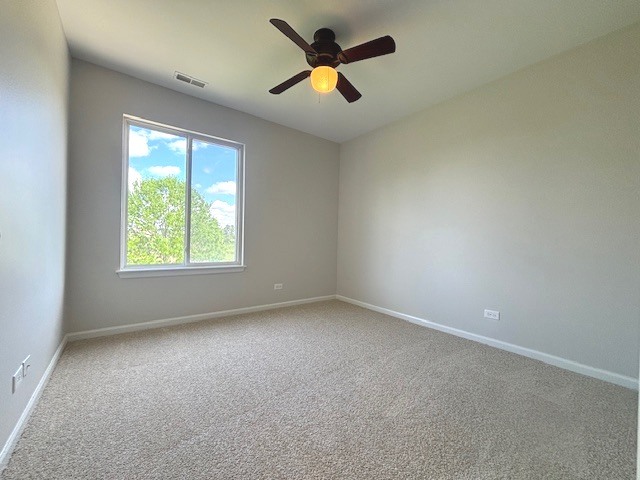 508 Ramsden Road Plano, IL 60545 - Photo 17 of 20 an empty room with windows and fan