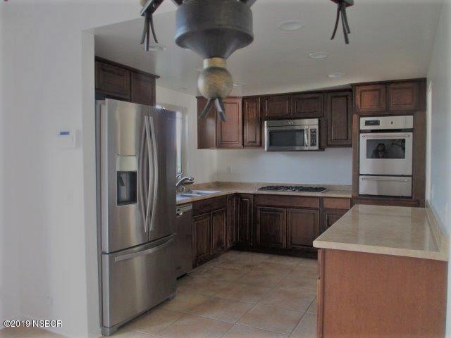 233 Huntington Place Lompoc, CA 93436 - Photo 3 of 7 a kitchen with stainless steel appliances granite countertop a refrigerator a stove a sink and dishwasher