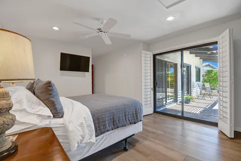 a bedroom with a bed and wooden floor