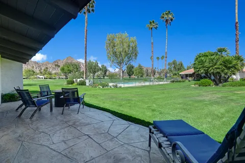 a view of house with outdoor space and sitting area