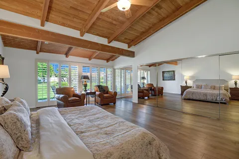 a living room with furniture window and wooden floor