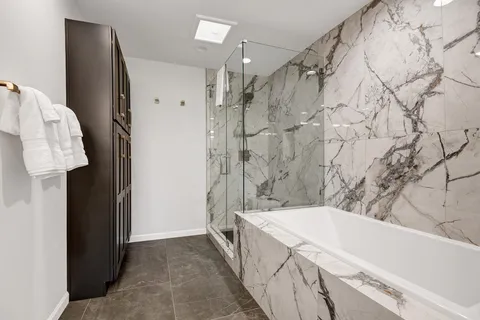 a bathroom with a bathtub and shower