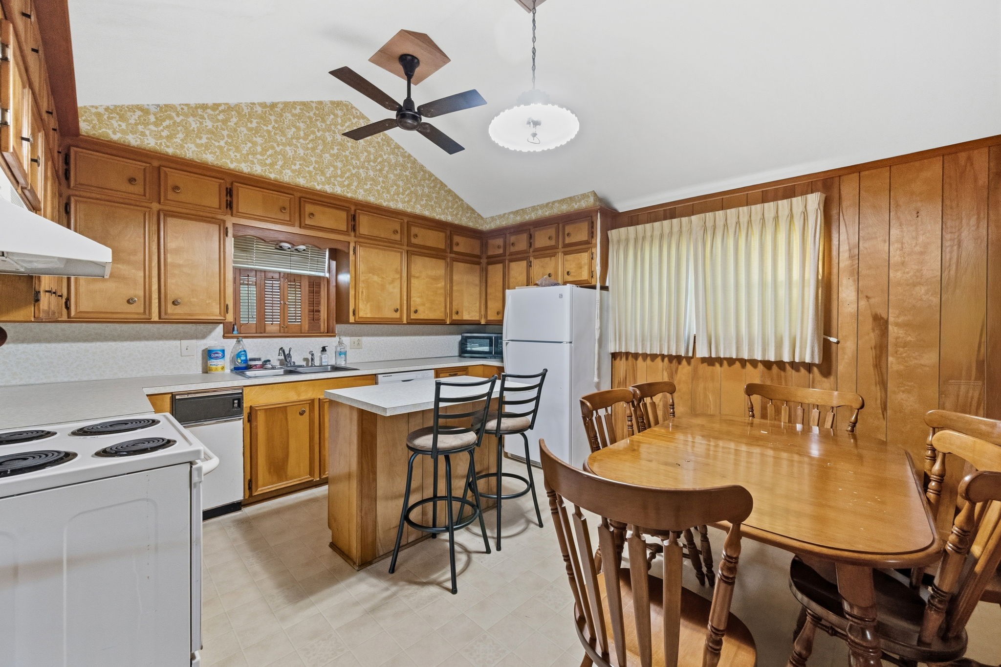804 North Cleveland Street Dayton, TX 77535 - Photo 12 of 29 a kitchen with stainless steel appliances kitchen island granite countertop a table chairs in it and wooden floors