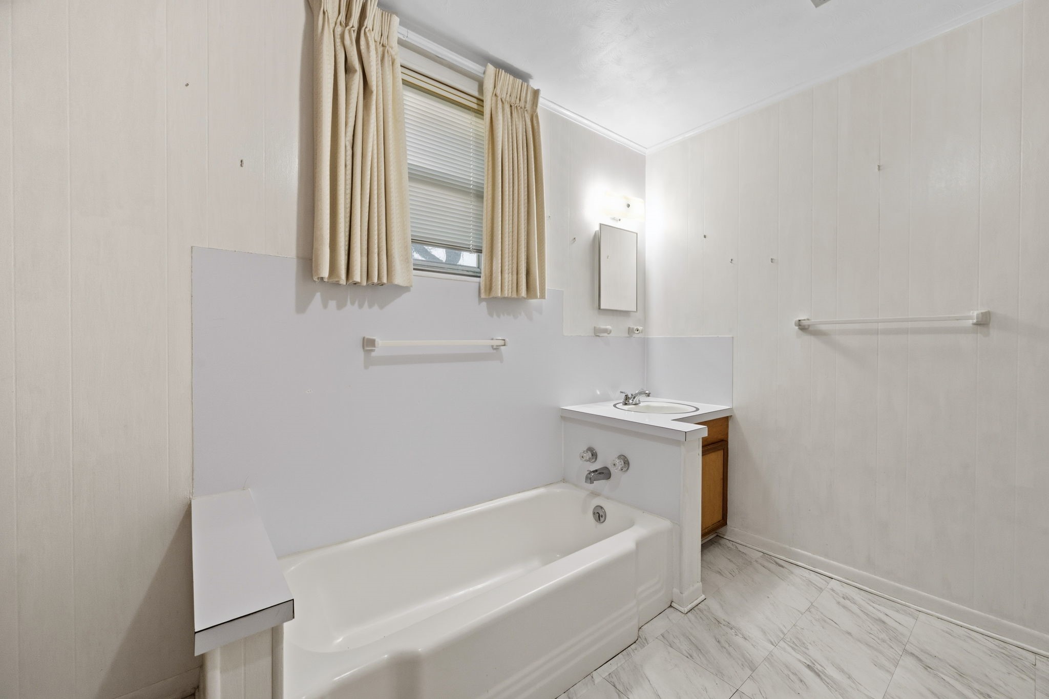 804 North Cleveland Street Dayton, TX 77535 - Photo 18 of 29 a bathroom with a tub sink and mirror