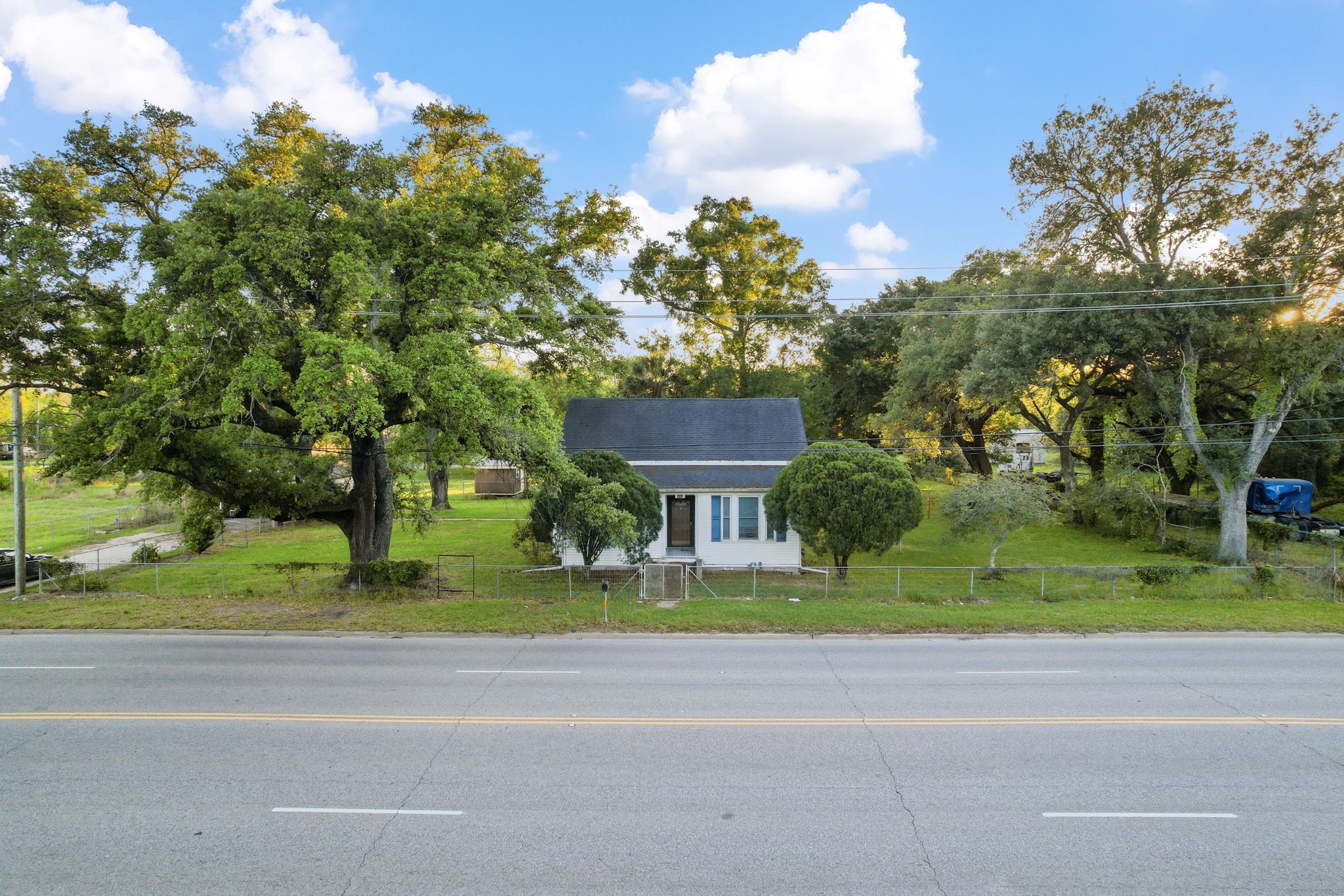 804 North Cleveland Street Dayton, TX 77535 - Photo 3 of 29 a view of street with houses and trees in the background