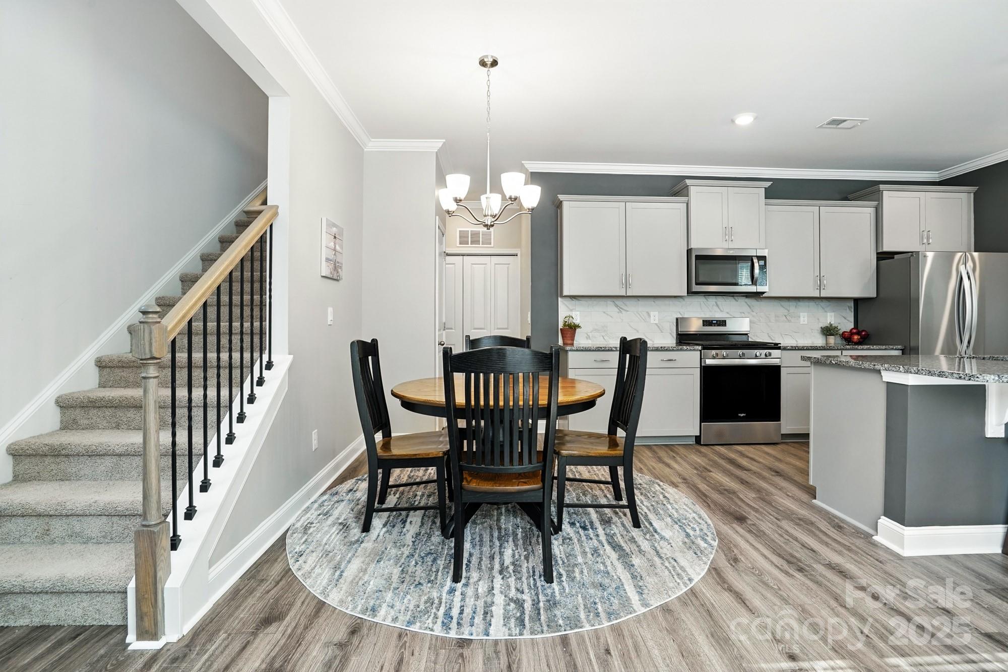 7882 Iron Road Sherrills Ford, NC 28673 - Photo 13 of 46 a view of a dining room with furniture and wooden floor