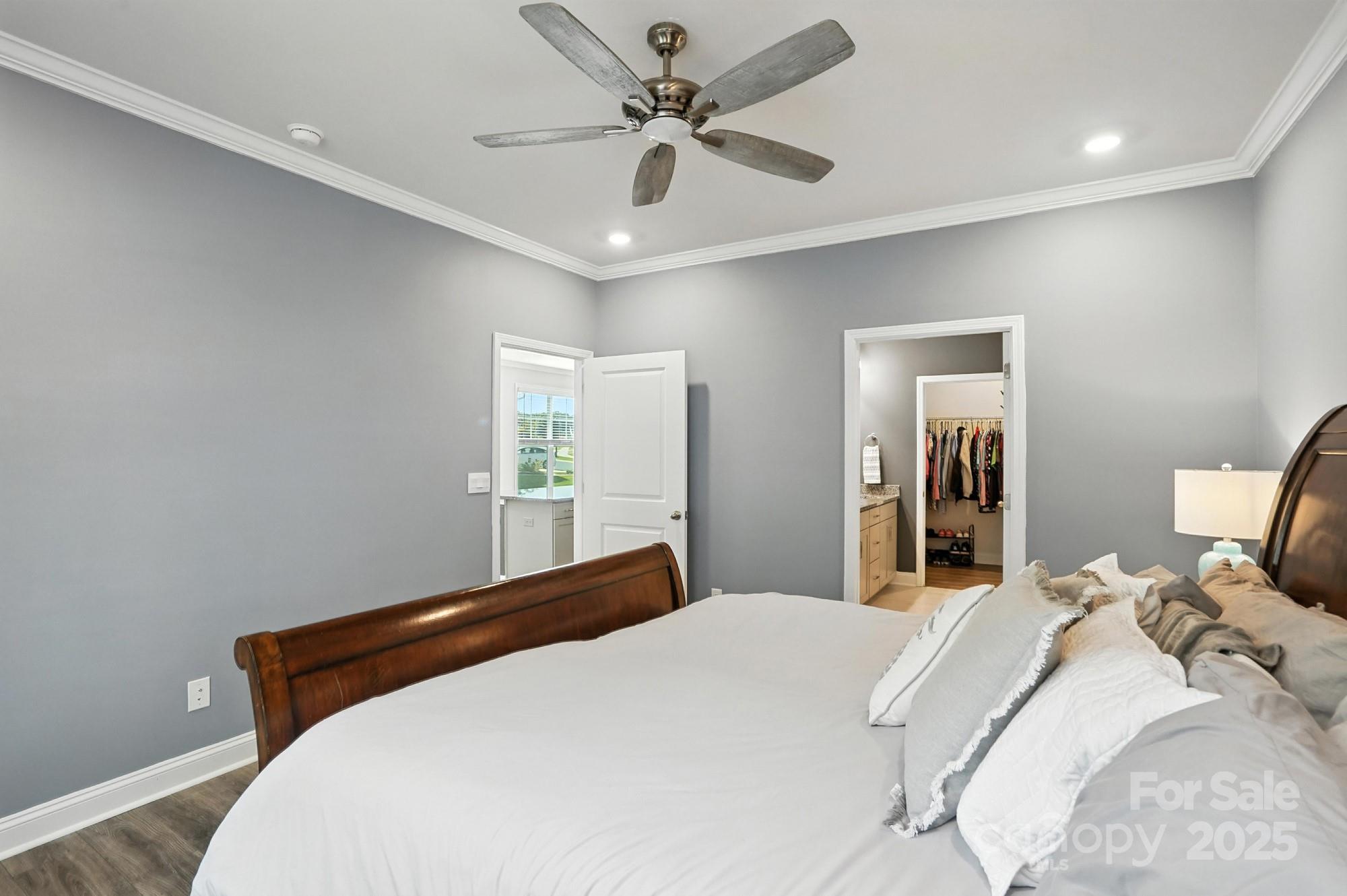 7882 Iron Road Sherrills Ford, NC 28673 - Photo 22 of 46 a bedroom with a large bed and a chandelier