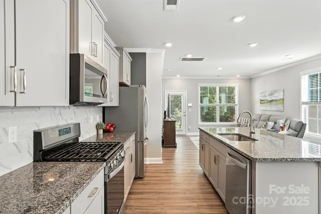 a living room with furniture wooden floor and a dining table