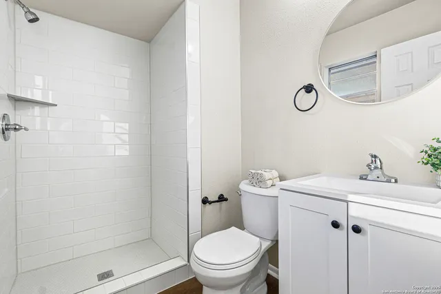 a bathroom with a sink toilet and shower
