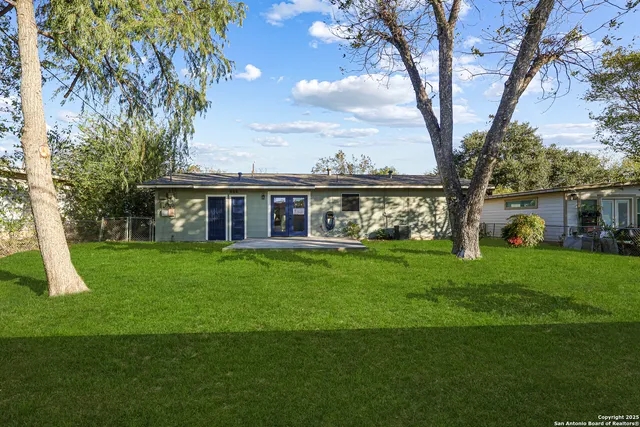 a view of a house with a yard from a patio