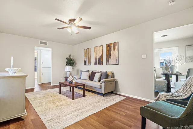 a living room with furniture and wooden floor