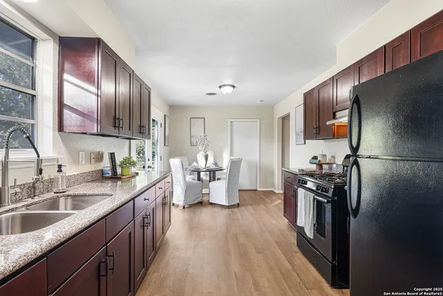 a kitchen with refrigerator cabinets and wooden floor