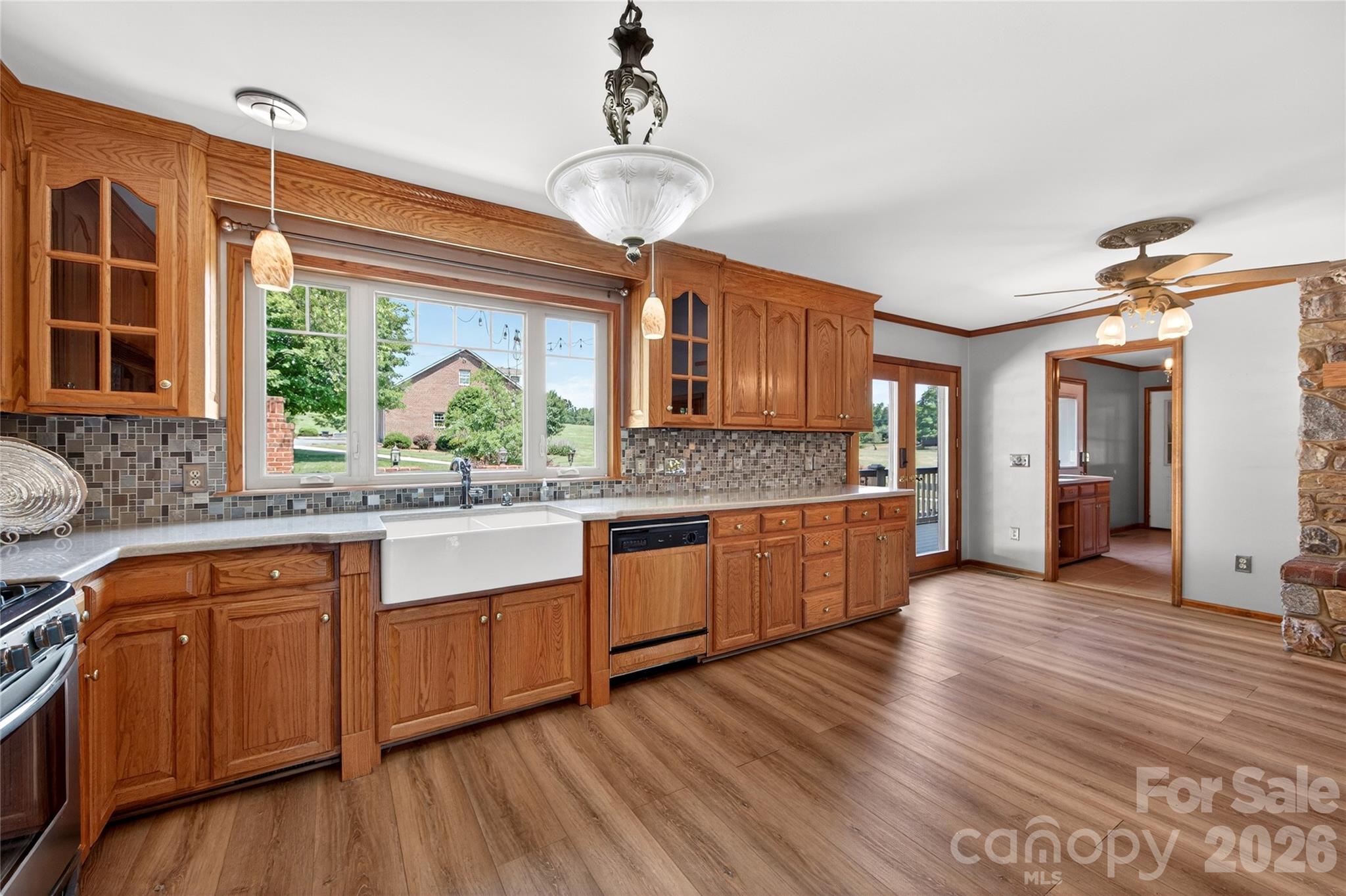 40659 Ridenhour Road Richfield, NC 28137 - Photo 8 of 25 a kitchen with stainless steel appliances granite countertop wooden floors and white cabinets