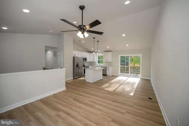 a kitchen with white cabinets and a window