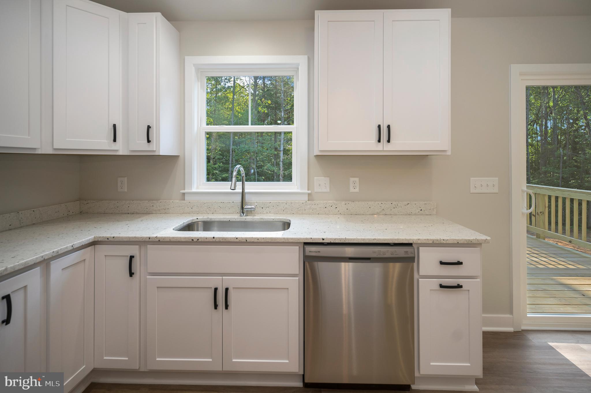 3145 Lewiston Road Bumpass, VA 23024 - Photo 20 of 44 a kitchen with white cabinets and a window