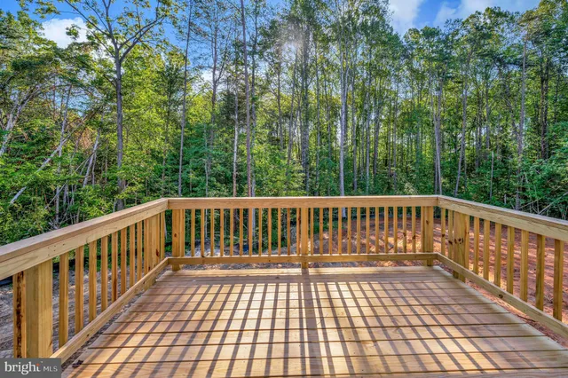 an empty room with windows and ceiling fan