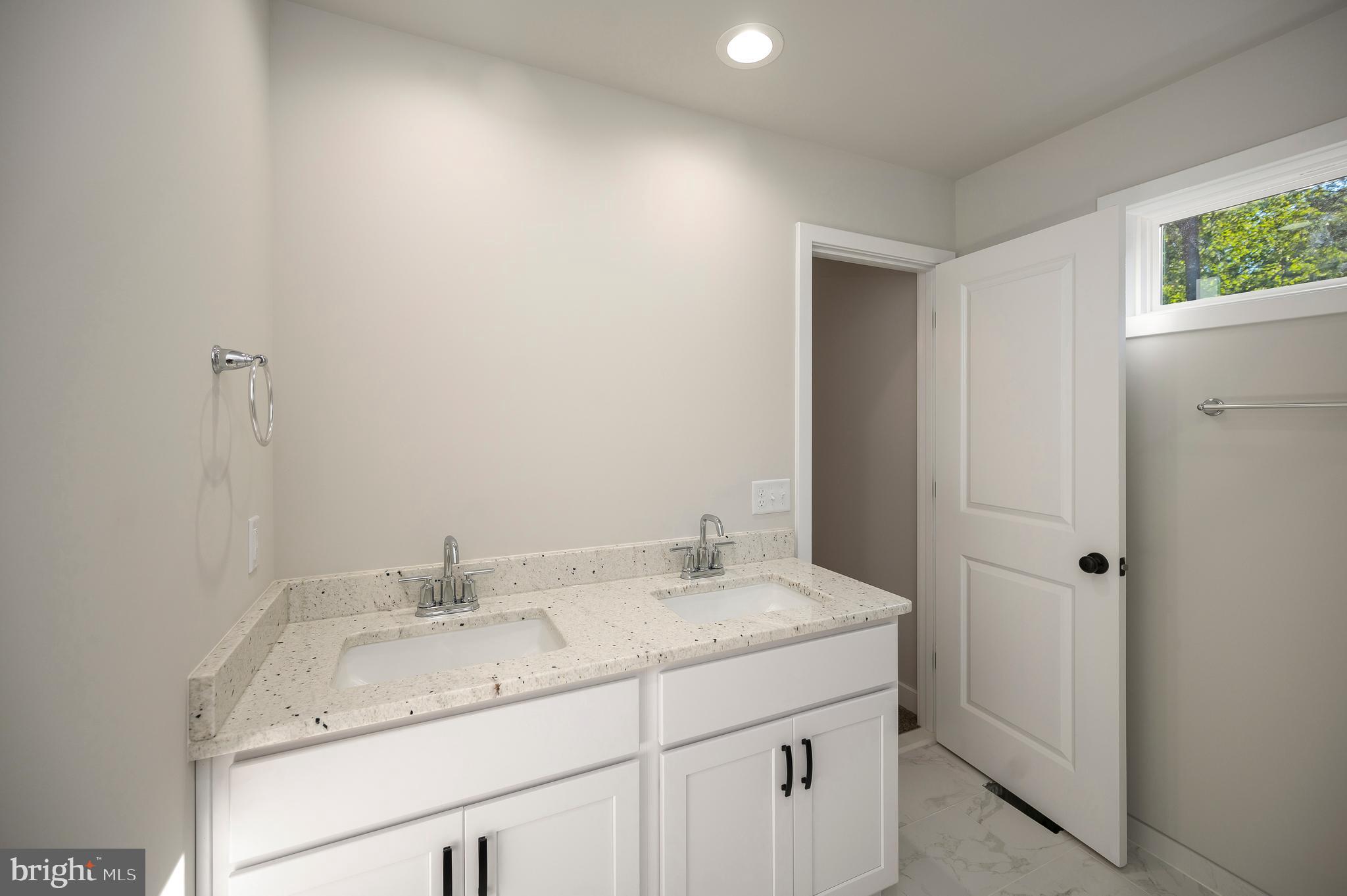 3145 Lewiston Road Bumpass, VA 23024 - Photo 27 of 44 a bathroom with a granite countertop sink and a mirror