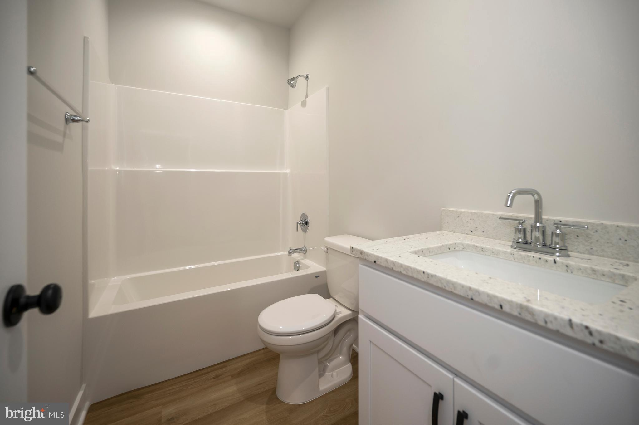 3145 Lewiston Road Bumpass, VA 23024 - Photo 35 of 44 a bathroom with a granite countertop sink toilet and shower