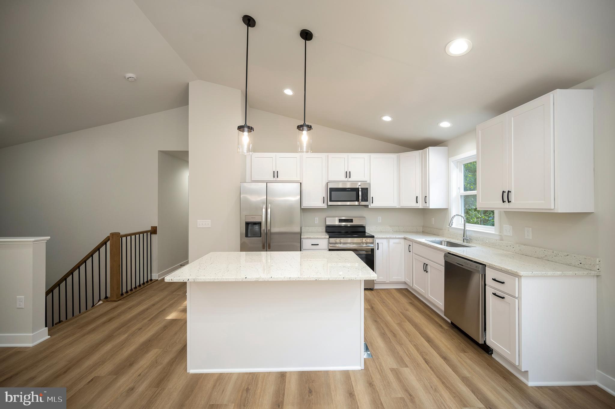 3145 Lewiston Road Bumpass, VA 23024 - Photo 6 of 44 a large kitchen with granite countertop a large counter top a sink stainless steel appliances and cabinets