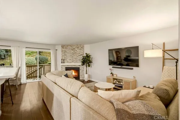 a living room with a couch a flat screen tv and a large window