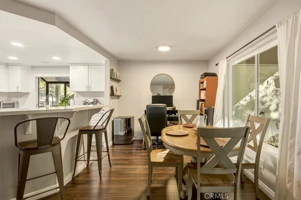 a dining room with furniture and wooden floor