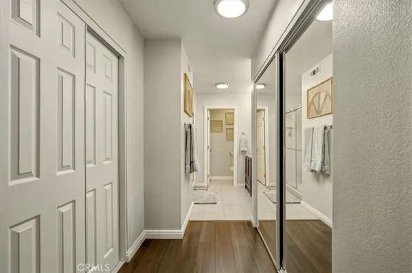 a view of a hallway with wooden floor and staircase
