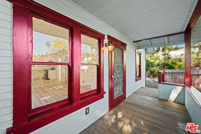 a view of a kitchen with a refrigerator wooden floor and a window