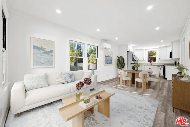 a living room with furniture a large window and a mirror