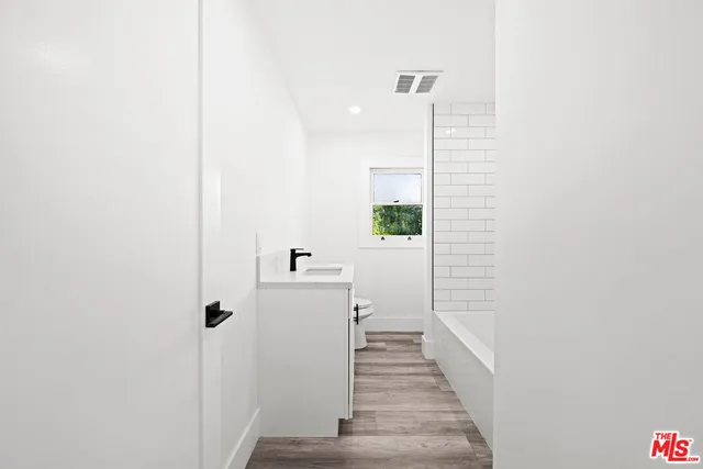 a view of backyard with swimming pool and seating space