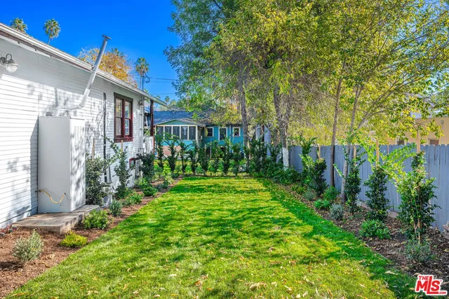 a front view of a house with a yard table and chairs