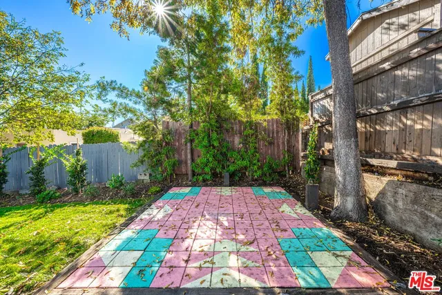 a view of a house with backyard and a tree