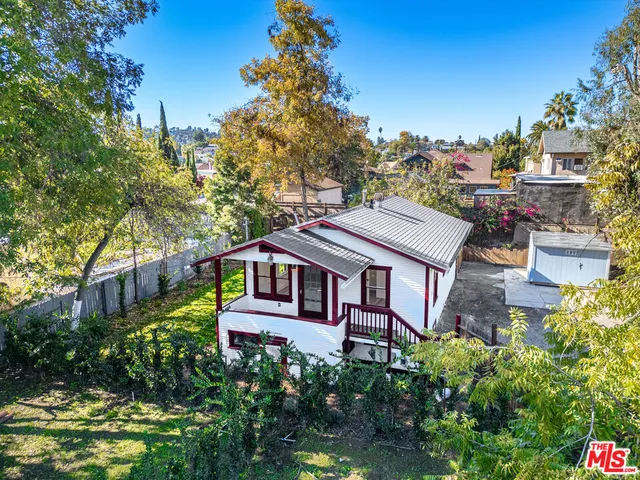 a aerial view of a house with a yard